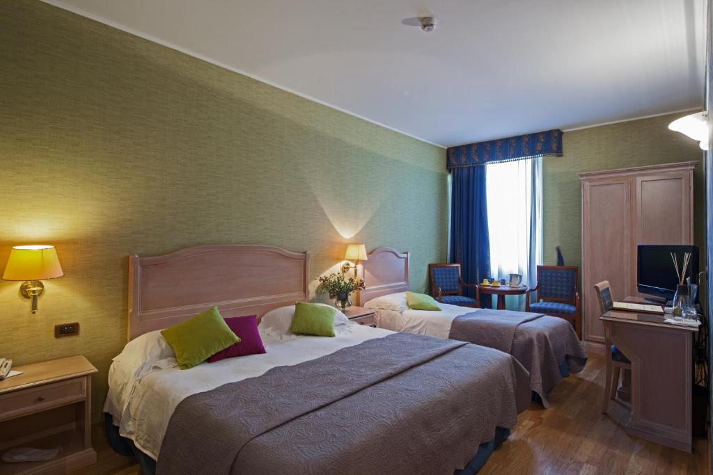Postel nebo postele na pokoji v ubytování Hotel Palazzo Lovera