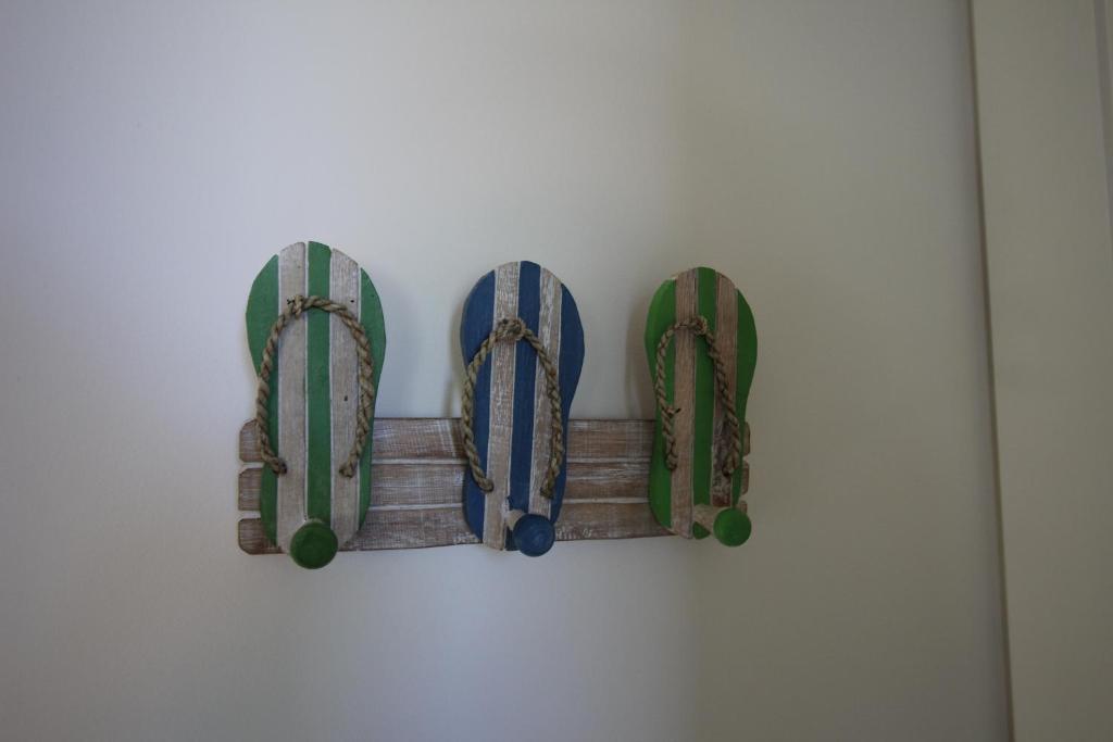 a group of four skateboards hanging on a wall at Lorne Holiday House in Lorne