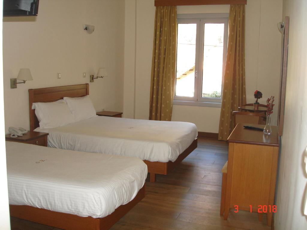 Posteľ alebo postele v izbe v ubytovaní Olympios Zeus Hotel