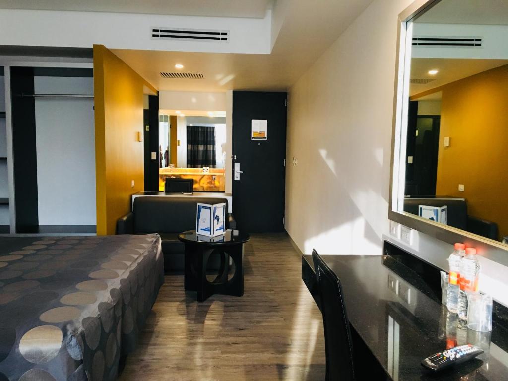 A compact double room with a bed, dressing desk and separate vanity area.