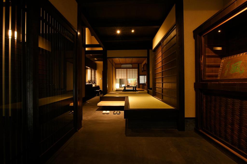 a hallway with mats in the middle of a room at Kuraya Omiya Shimabara in Kyoto