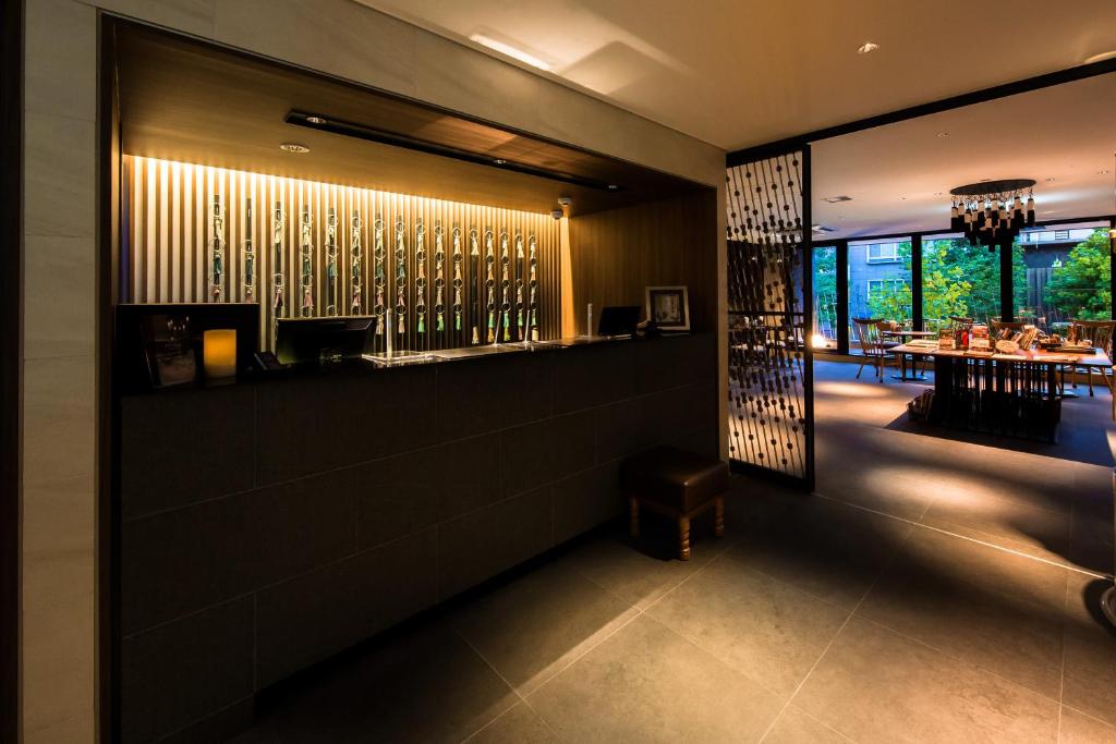 a dining room with a bar and a restaurant at Kyoto Itoya Hotel in Kyoto