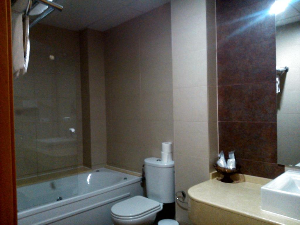 a bathroom with a tub and a toilet and a sink at Hotel Las Canteras de Puerto Real in Puerto Real