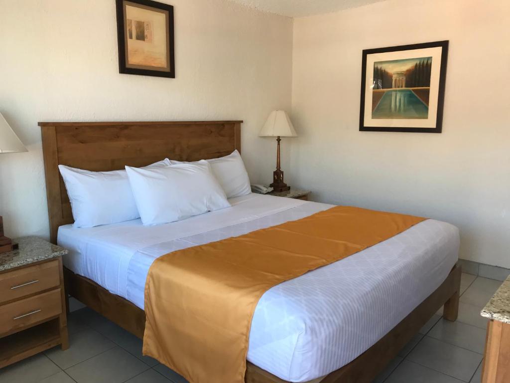 a bedroom with a large bed in a hotel room at Hotel Guillen Jr in Tijuana