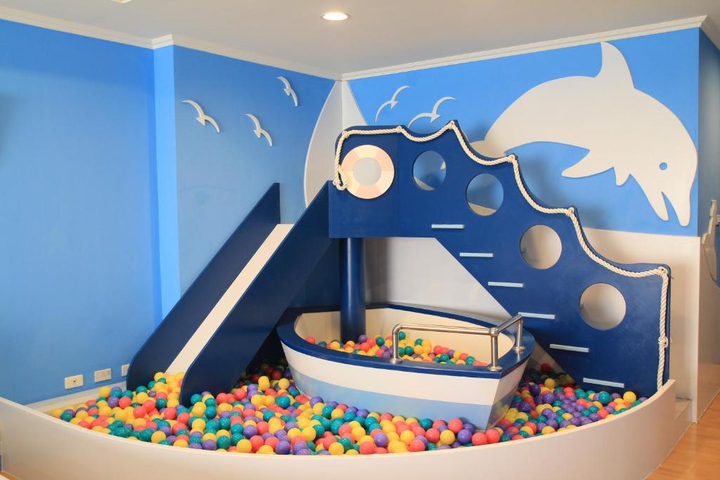 a childs play room with a ball pit and a slide at Kid Baby Homestay in Tainan