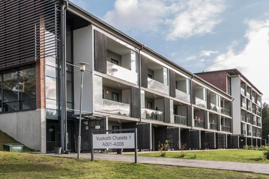 un edificio con una señal delante de él en Vuokatti Sport Chalets, en Vuokatti