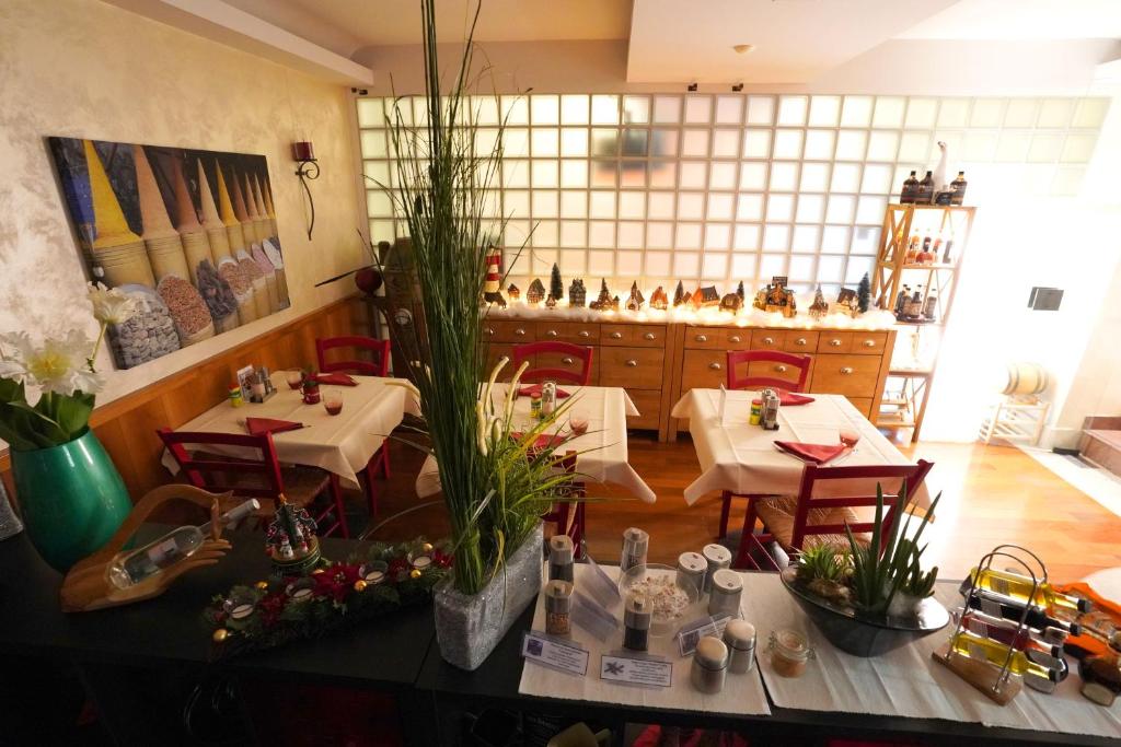 a restaurant with two tables and chairs in a room at Hotel Bahnhof Haus in Chiasso