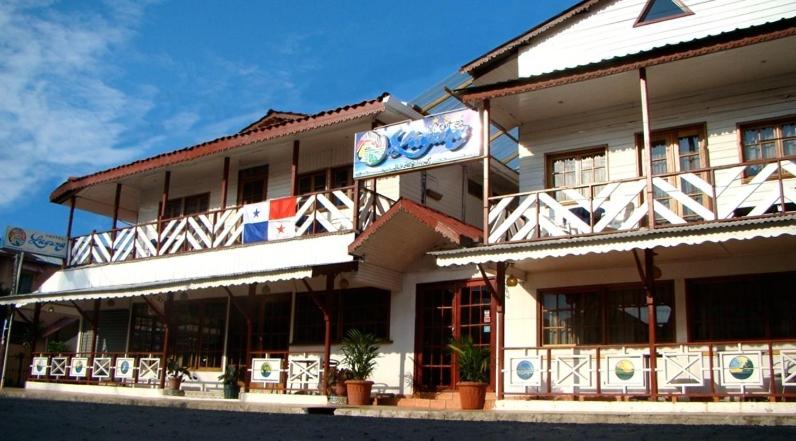 a building with a sign on the side of it at Hotel Laguna in Bocas Town