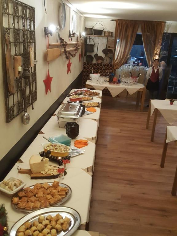 a buffet line with many different types of food at Hotel Bahnhof Haus in Chiasso