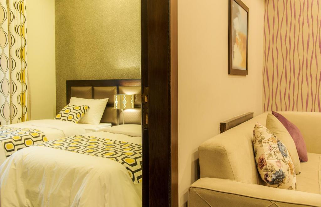 
A bed or beds in a room at Shams Alweibdeh Hotel Apartments
