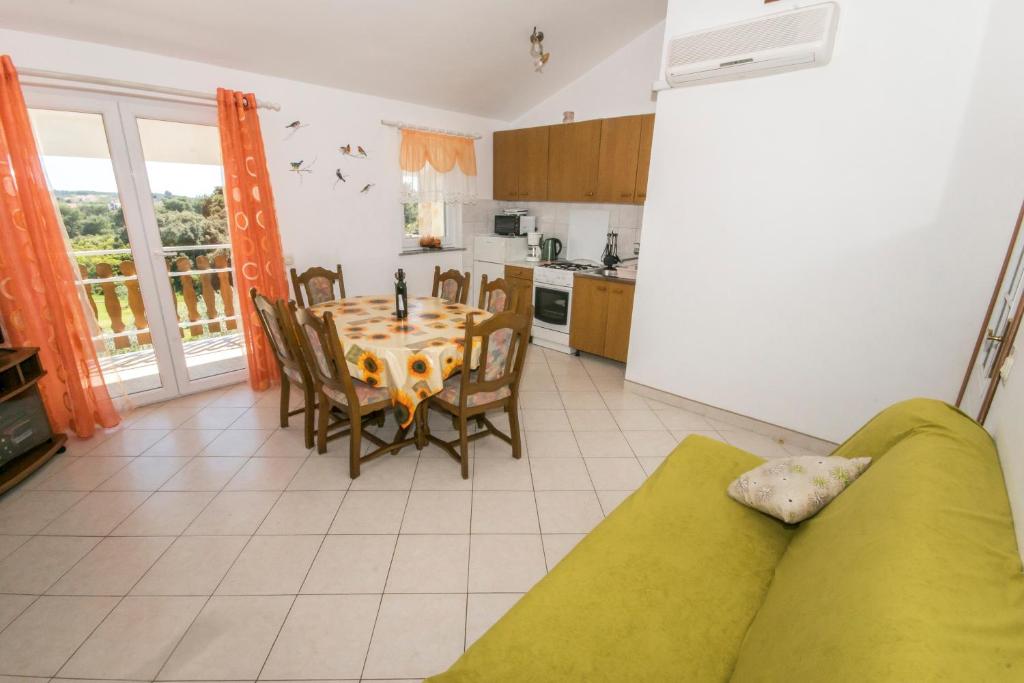 a kitchen and dining room with a table and chairs at Apartment Ana in Pula