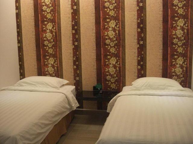 Postel nebo postele na pokoji v ubytování Marvelot Hotel
