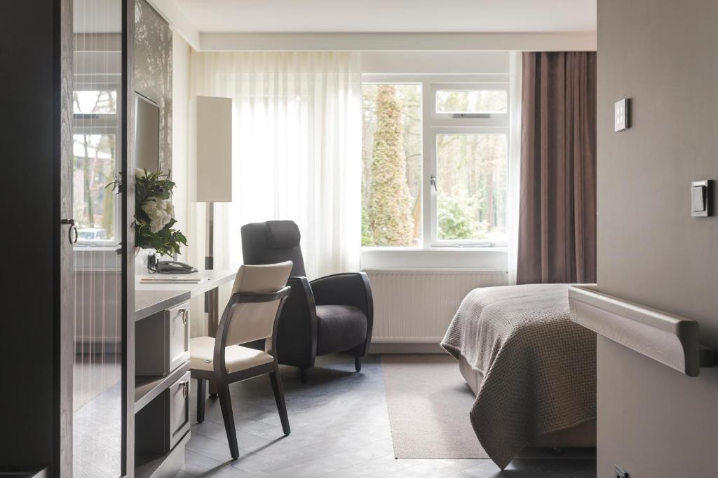 Postel nebo postele na pokoji v ubytování Hotel de Hoeve van Nunspeet