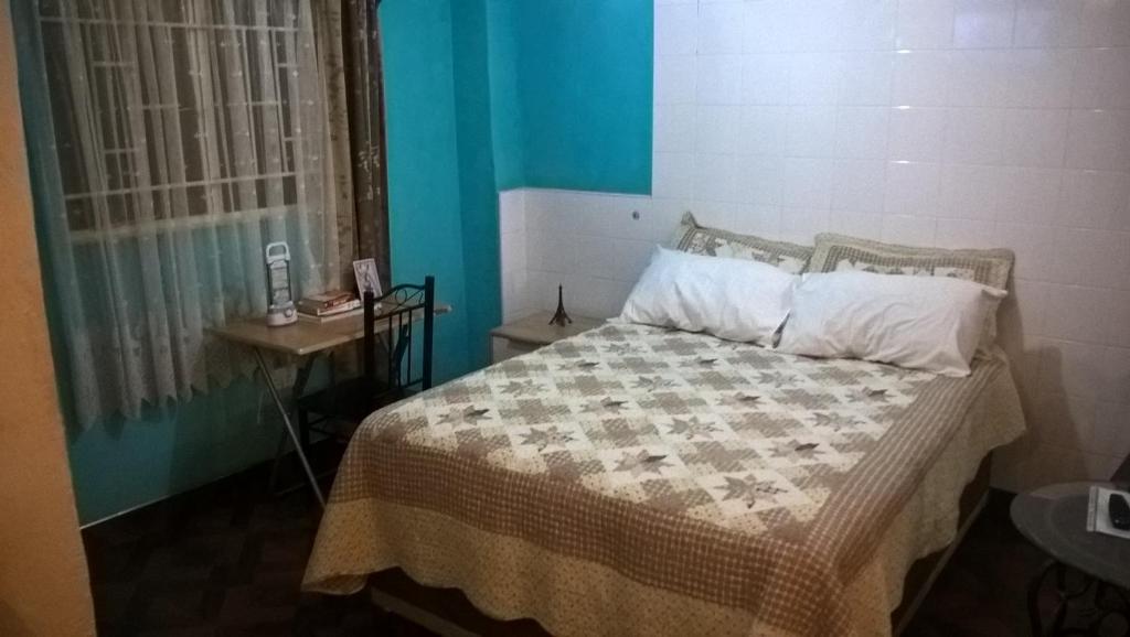 ルサカにあるFurnished self-catering guest wingのベッドルーム1室(ベッド1台、テーブル、窓付)
