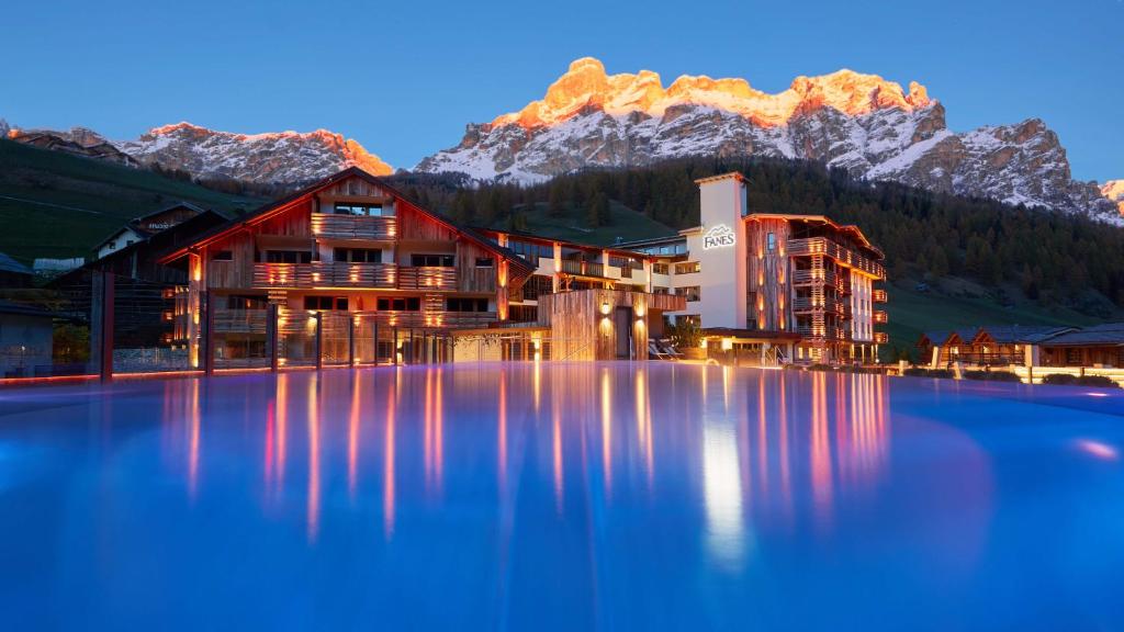 a hotel with a mountain in the background at Hotel Fanes in San Cassiano