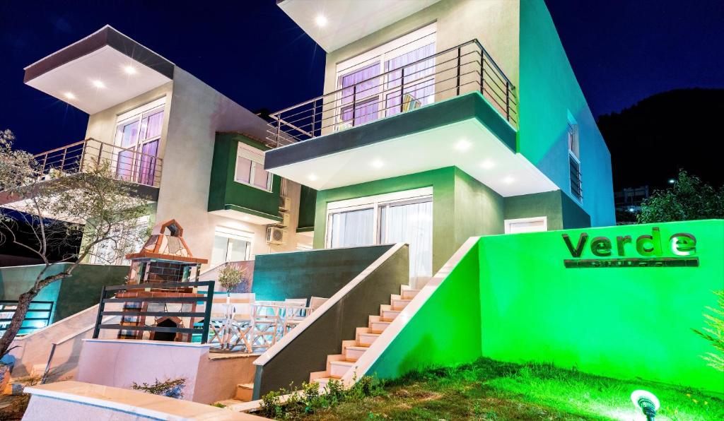 a large house with a green screen in front of it at Verde Villas in Skala Potamias