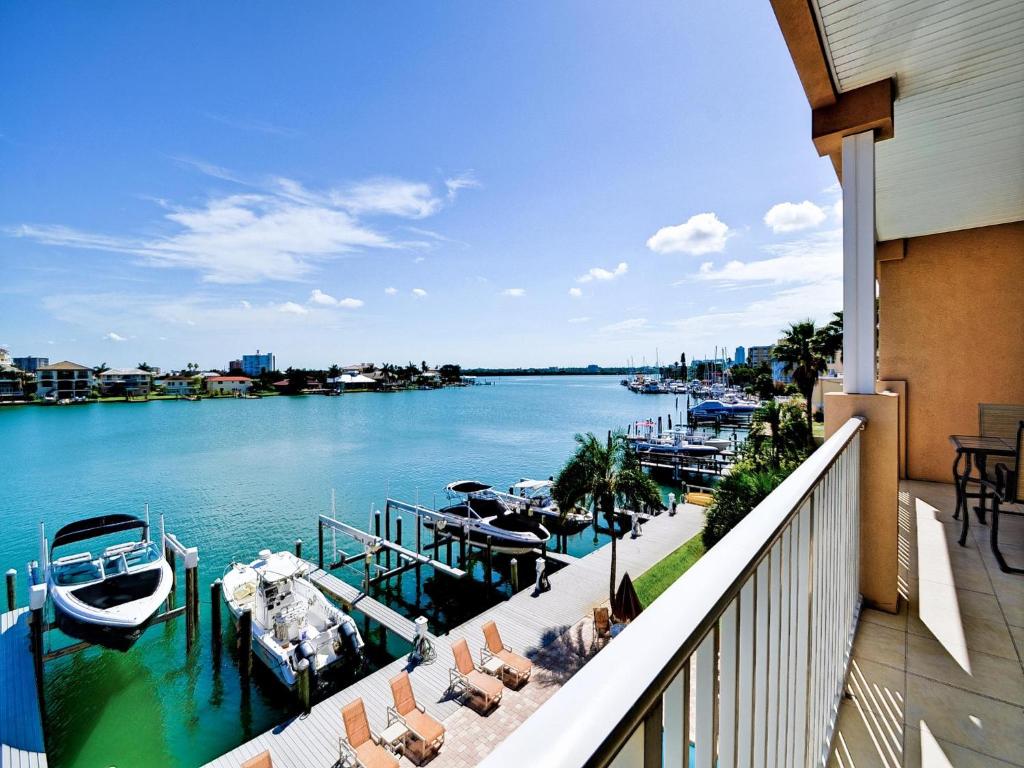 a balcony with a view of a river with boats at Island Key Condos 302 in Clearwater Beach