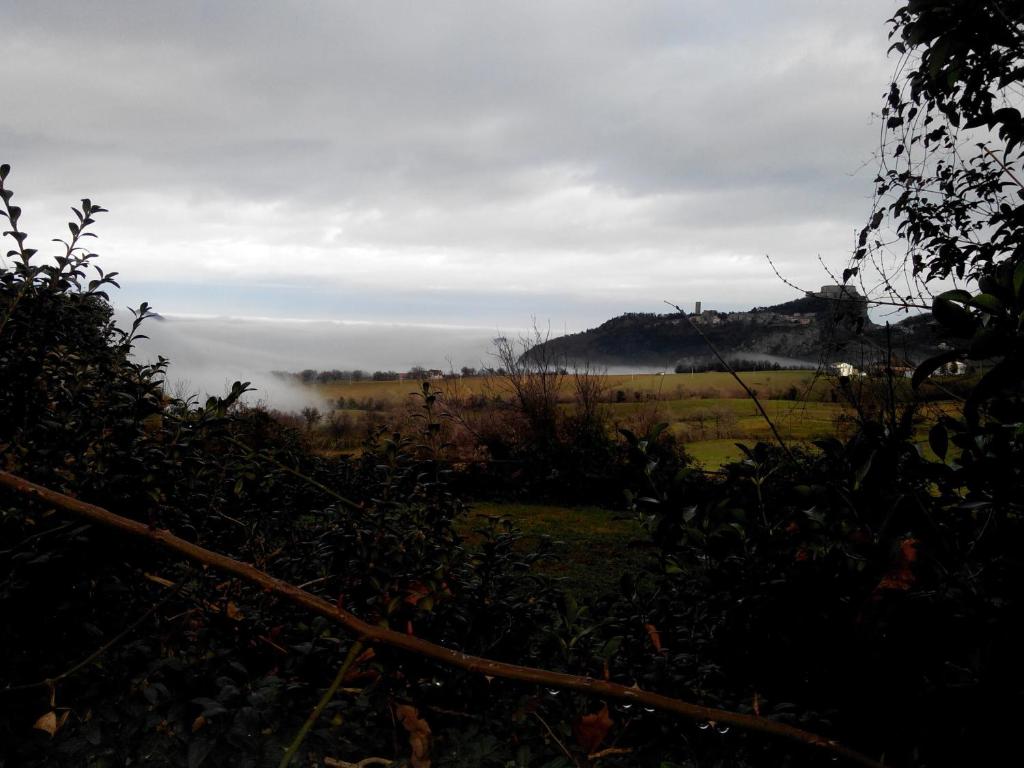 a view of a field with fog in the distance at B&B Le Due Rocche in Maiolo