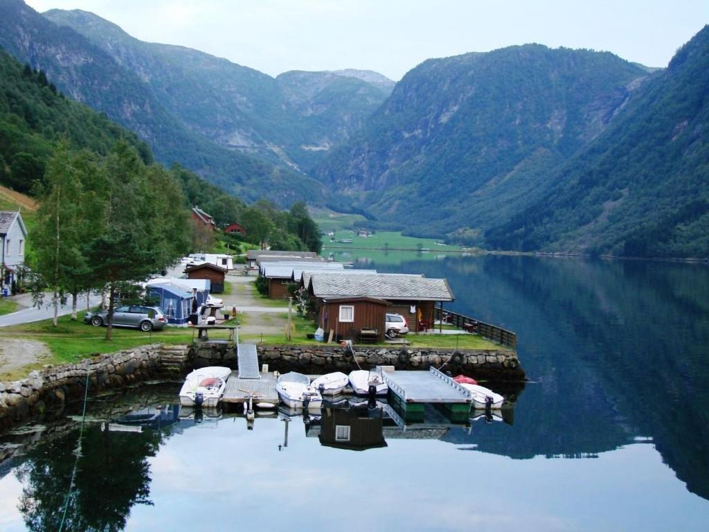 a group of boats docked at a dock on a lake at Nesheim Hytter & Camping in Bjordal