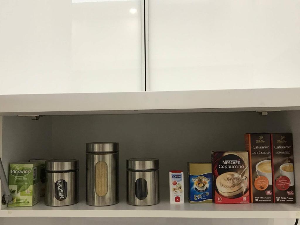 a shelf with various food items on it at Manyi Apartman in Debrecen