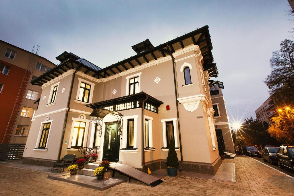 a large white house on a city street at Prestige Hotel in Iaşi