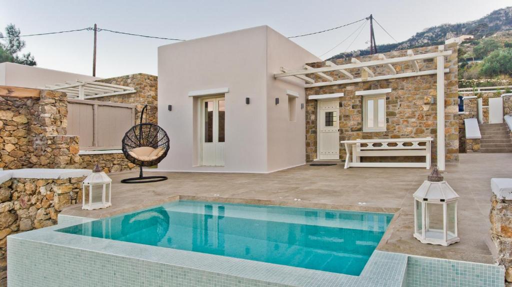 a villa with a swimming pool and a house at Lux View Villas in Kyra Panagia