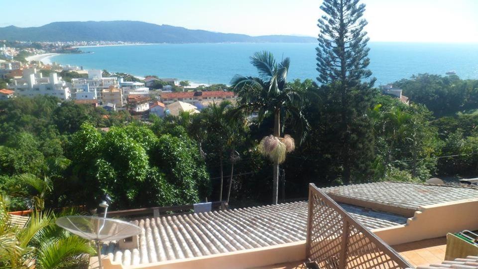 a balcony of a house with a view of the ocean at Pousada Buganvilia in Bombinhas