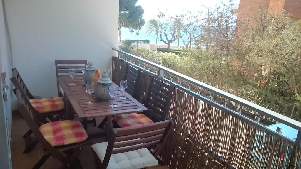 a wooden table and chairs on a balcony at My2ndHome in Hospitalet de l'Infant