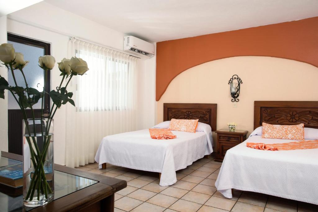 Postel nebo postele na pokoji v ubytování Hotel El Pescador