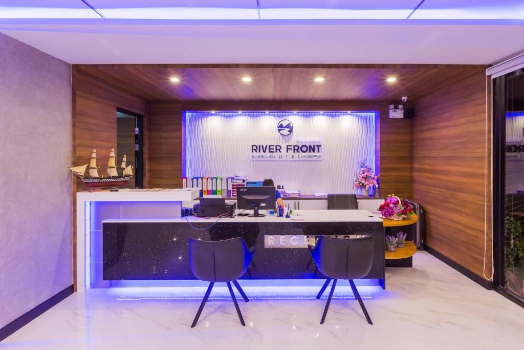 an office with a reception desk with a larger front at River Front Krabi Hotel in Krabi