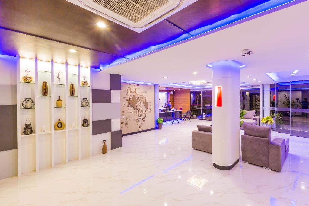 a lobby of a building with chairs and a column at River Front Krabi Hotel in Krabi