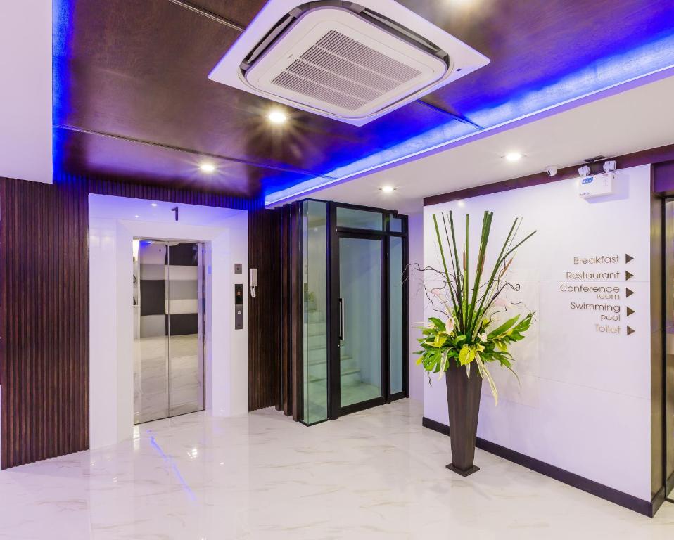 an office lobby with a ceiling fan and a plant at River Front Krabi Hotel in Krabi