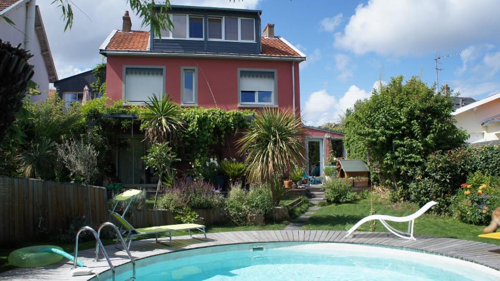 a house with a swimming pool in front of a house at Annexe 44 in Nantes