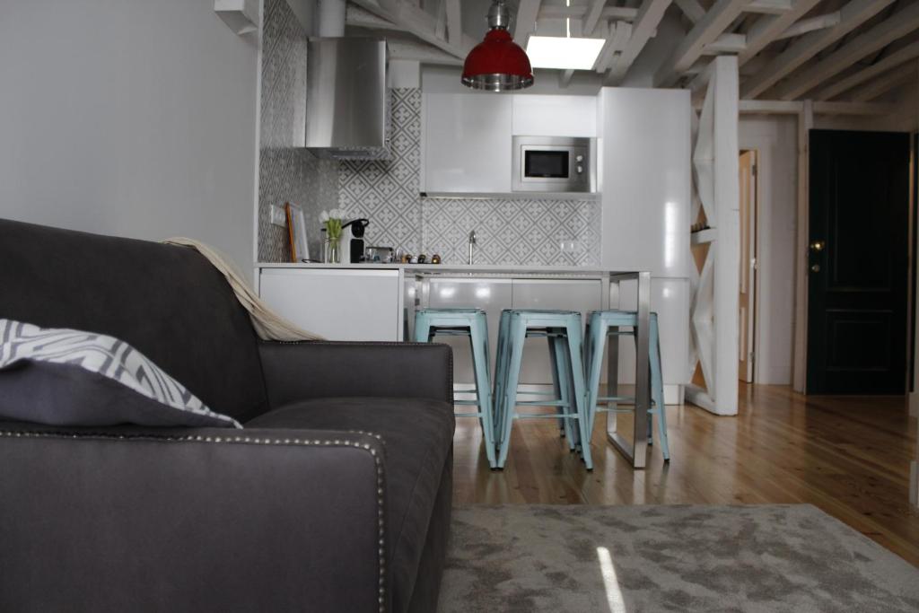 a living room with a couch and a kitchen at Augusta Street 213 - 4 Dto in Lisbon