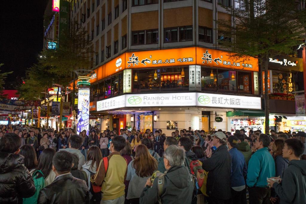 a crowd of people standing in front of a building at Rainbow Hotel in Taipei