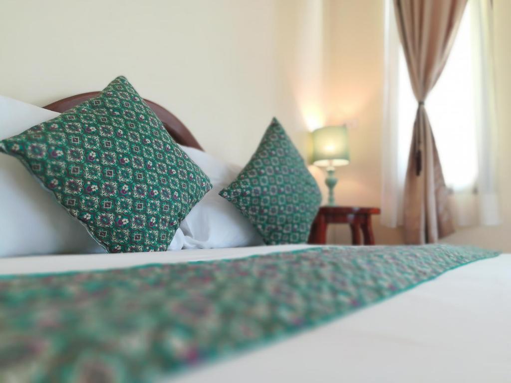 Postel nebo postele na pokoji v ubytování Baan Bussaba Hotel