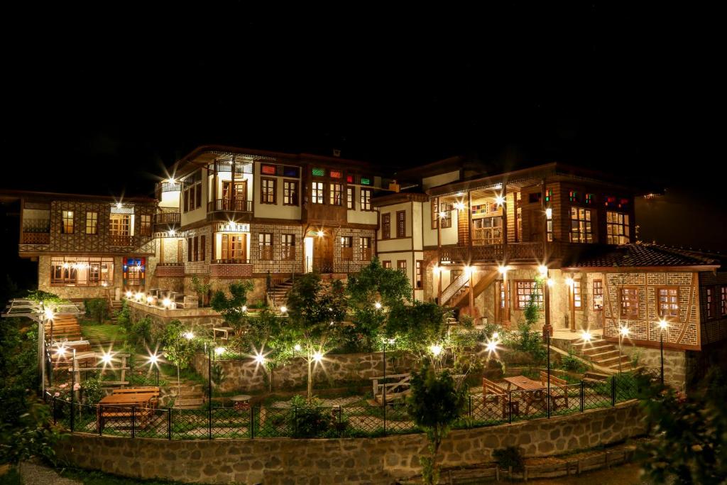a group of buildings with lights at night at Kaf Dagi Konak Hotel in Rize