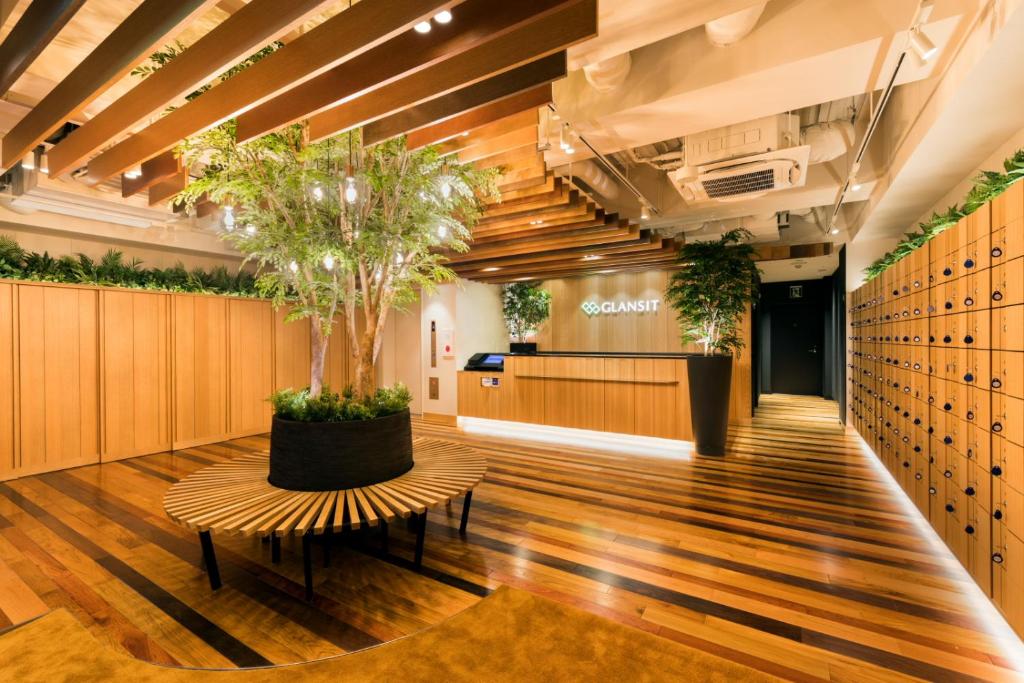 a tree in the middle of a lobby at Glansit Akihabara in Tokyo