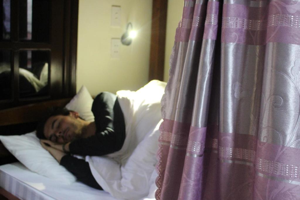 Postel nebo postele na pokoji v ubytování Ha Giang 1 Hostel and Loop Tour