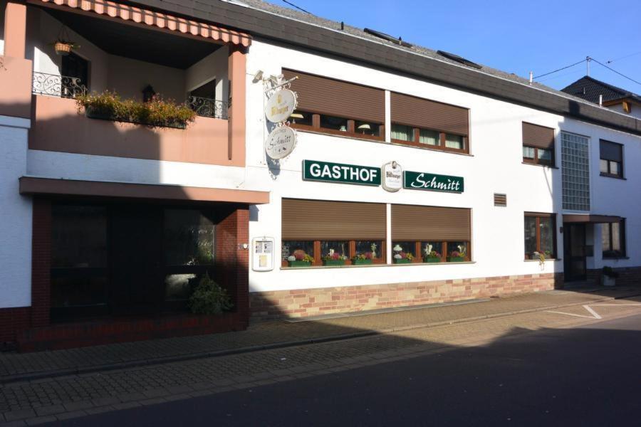 a white building with a sign on the side of it at Gasthof Schmitt in Merzig