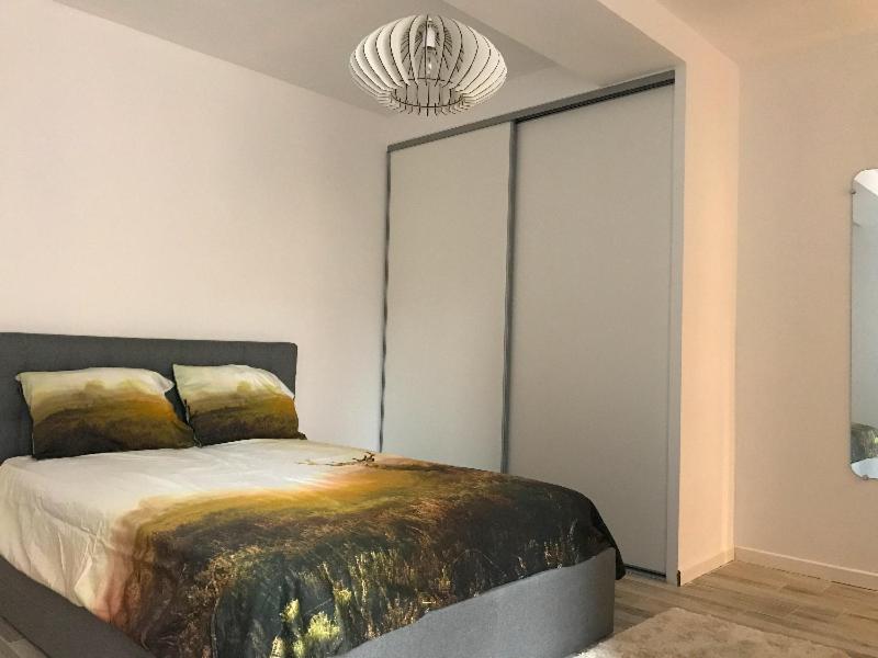 アジャクシオにあるAppartement de charme centre ville historique Ajaccioのベッドルーム1室(ベッド1台付)、大きなスライドドアが備わります。