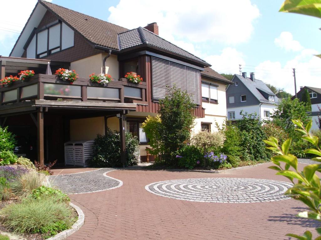 a house with a brick walkway in front of it at Ferienwohnungen Rump in Hilchenbach