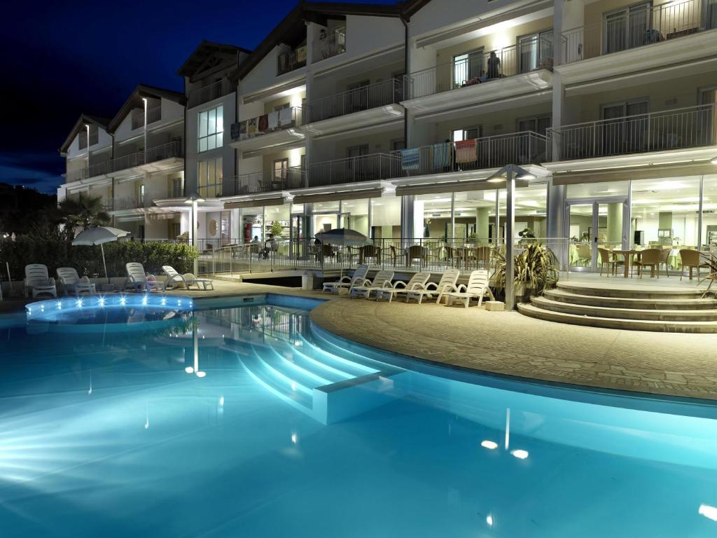 a hotel with a swimming pool at night at Casa Del Mar in Roseto degli Abruzzi