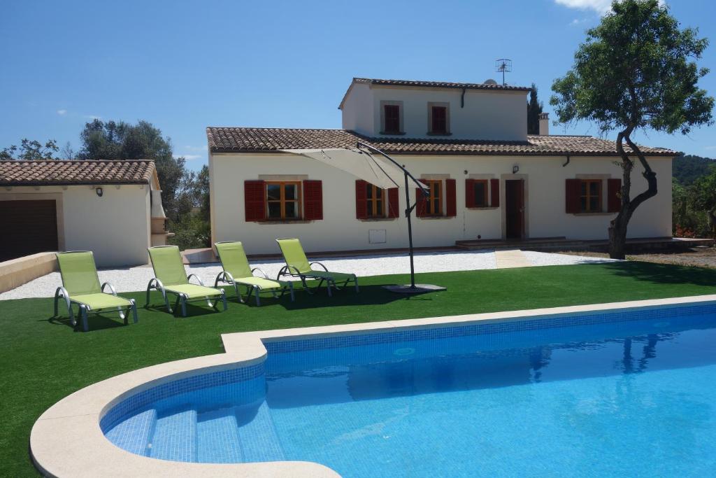a villa with a swimming pool in front of a house at Ca'n Bernat in Son Servera