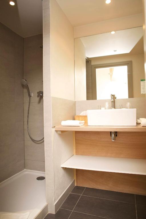 a bathroom with a sink and a shower at Hôtel Val d'Este in Saint-Gervais-les-Bains