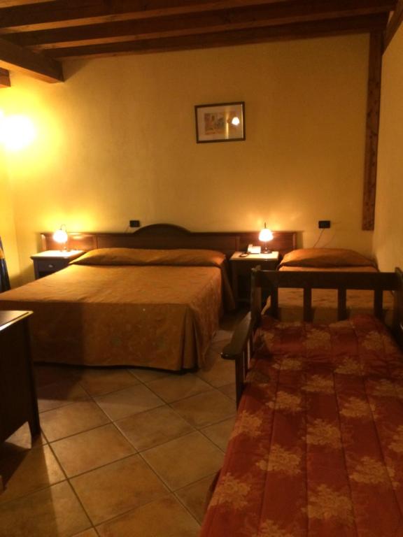 Postel nebo postele na pokoji v ubytování Hotel Cà Fiore