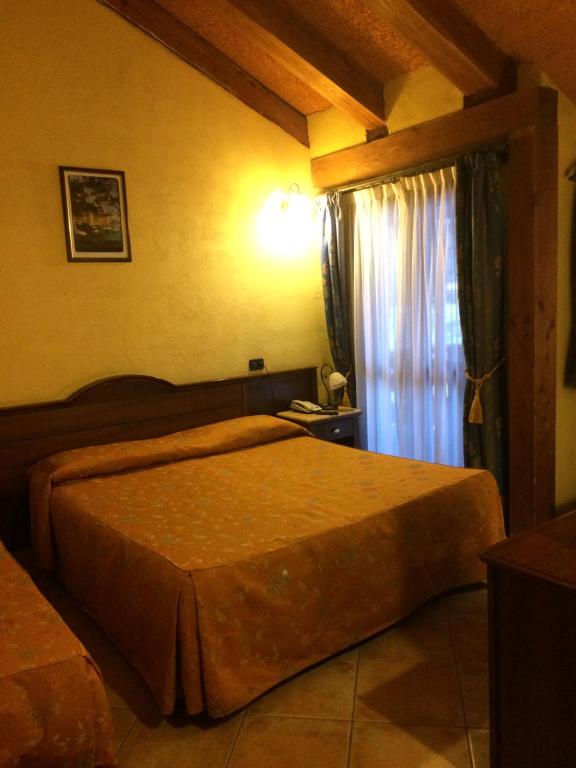 Postel nebo postele na pokoji v ubytování Hotel Cà Fiore
