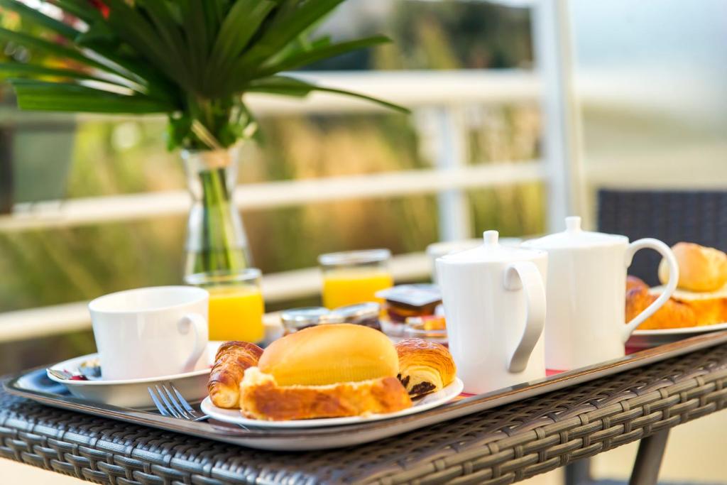 a tray of breakfast food on a table at Almoria Hôtel & SPA in Deauville