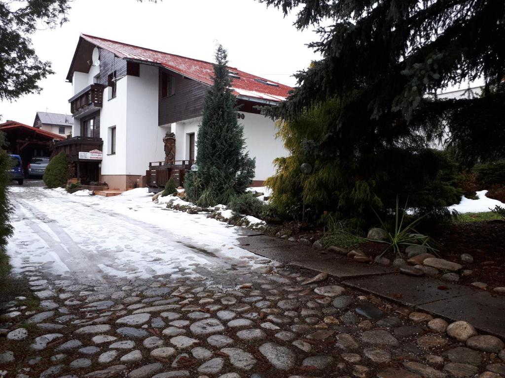 a cobblestone street in front of a house at Privát - Melanie in Vrchlabí