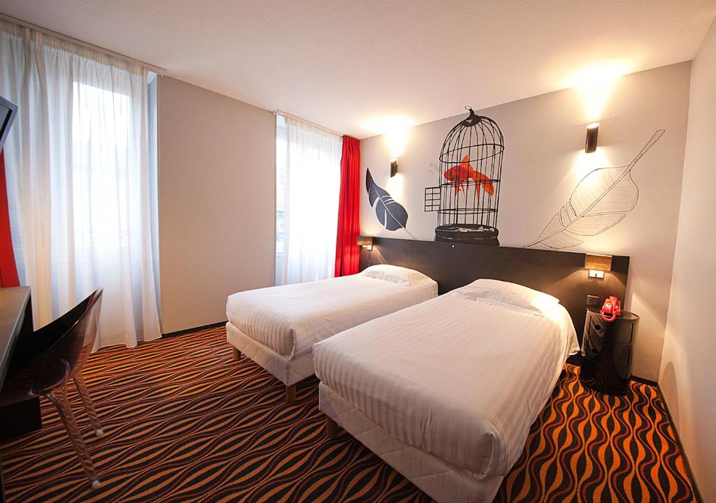 Postel nebo postele na pokoji v ubytování CIT'HÔTEL LE DAV Clermont-Ferrand Centre
